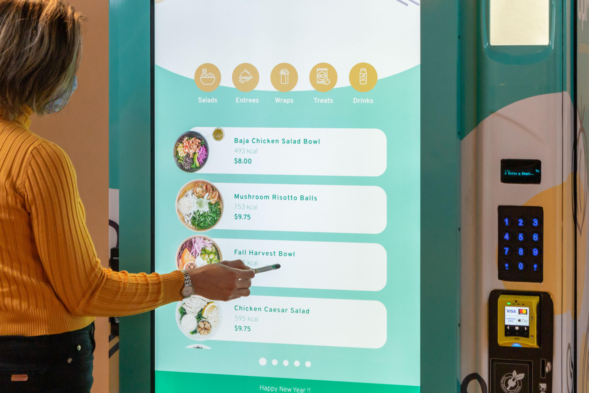 Office employee buying healthy food through UpMeals SmartVending machine.